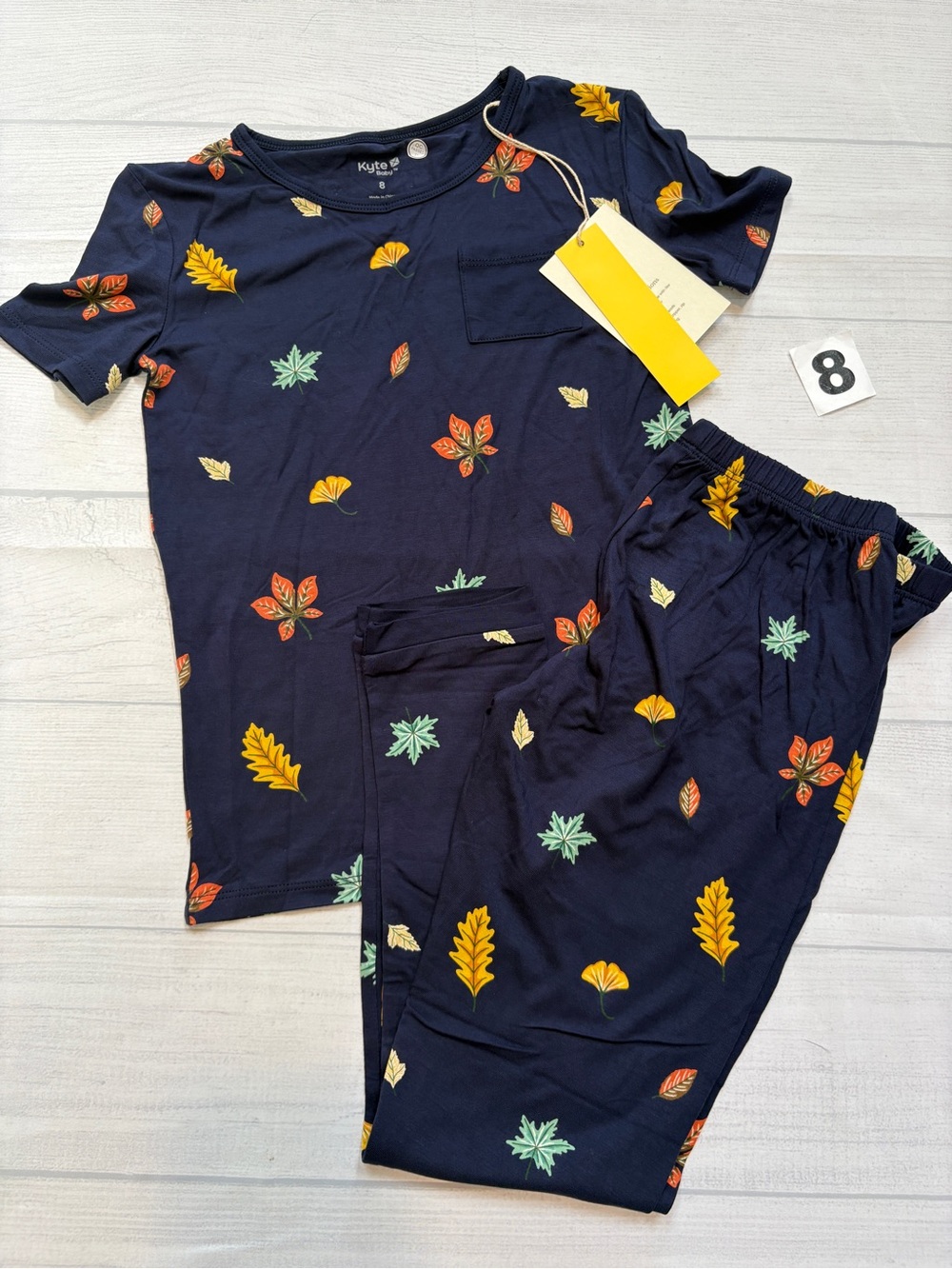 Kyte BABY navy leaf print pajama set with multicolor leaves
